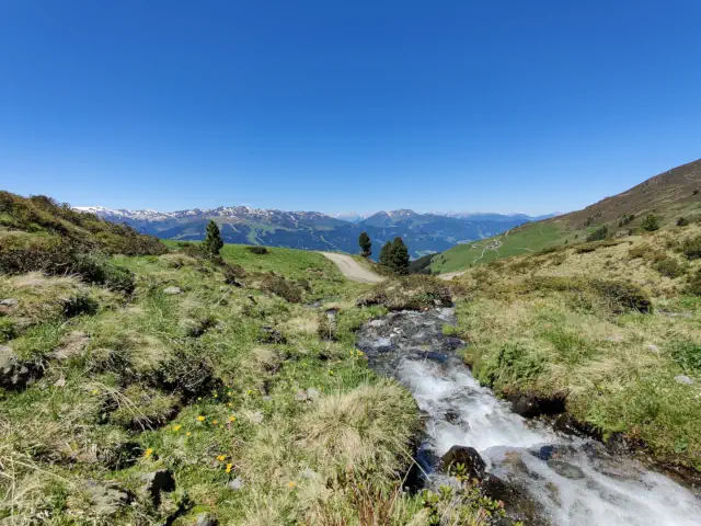 A mountain stream with a beatiful view over the alps.